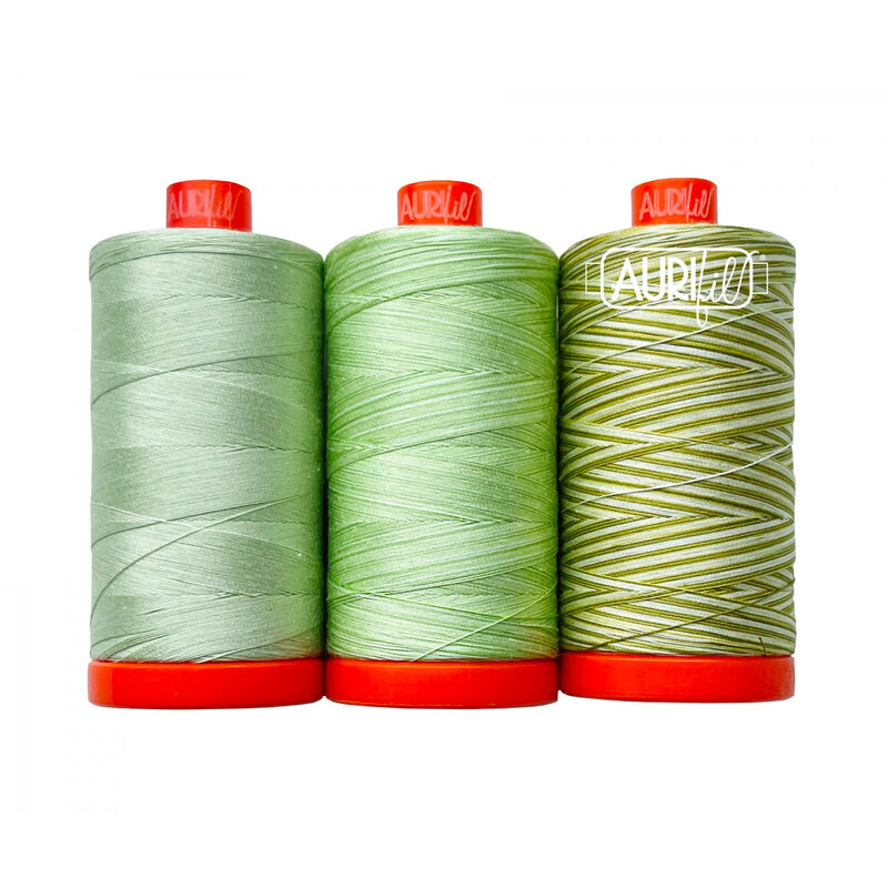 Three spools of various green Aurifil thread from the Walking Palm color builder set