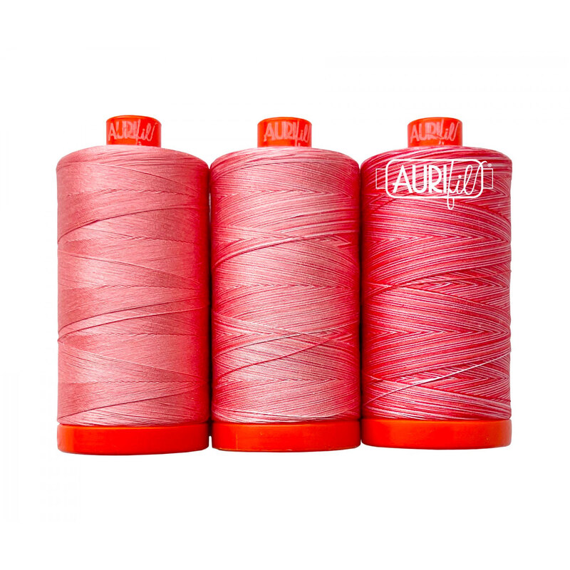Three pink thread spools from Aurifil's Stinking Corpse Lily thread set