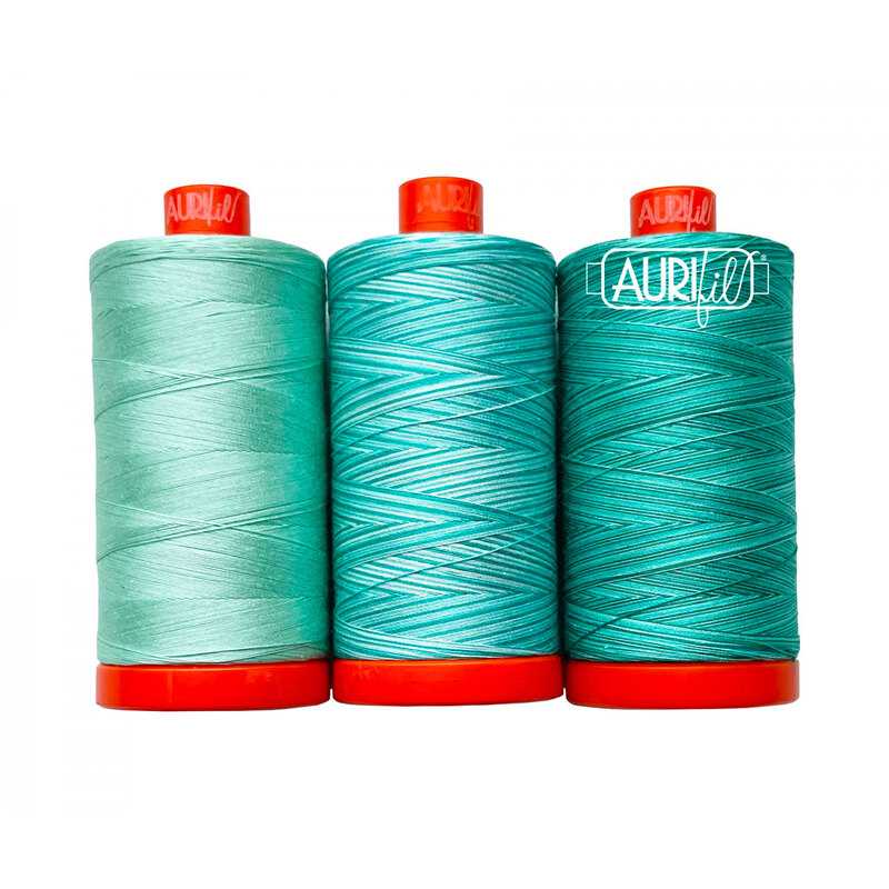 A set of 3 teal threads included in the Aurifil Color Builder Jade Vine set