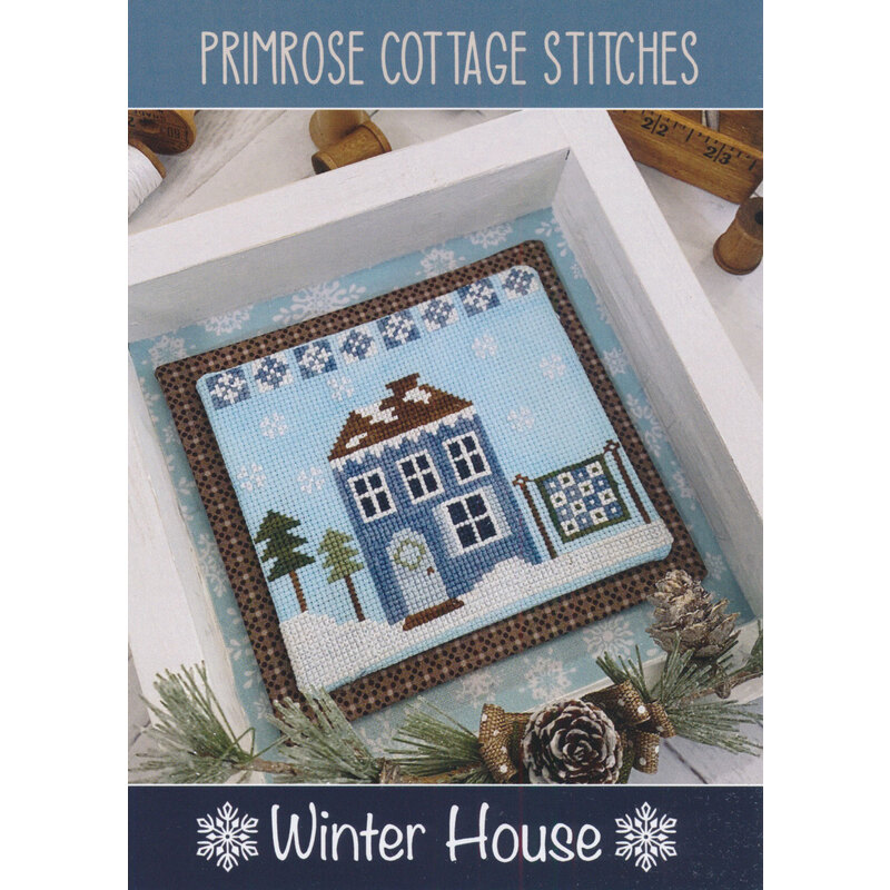 The front of the Winter House Cross Stitch Pattern by Lindsey Weight for Primrose Cottage Stitches showing the finished project.