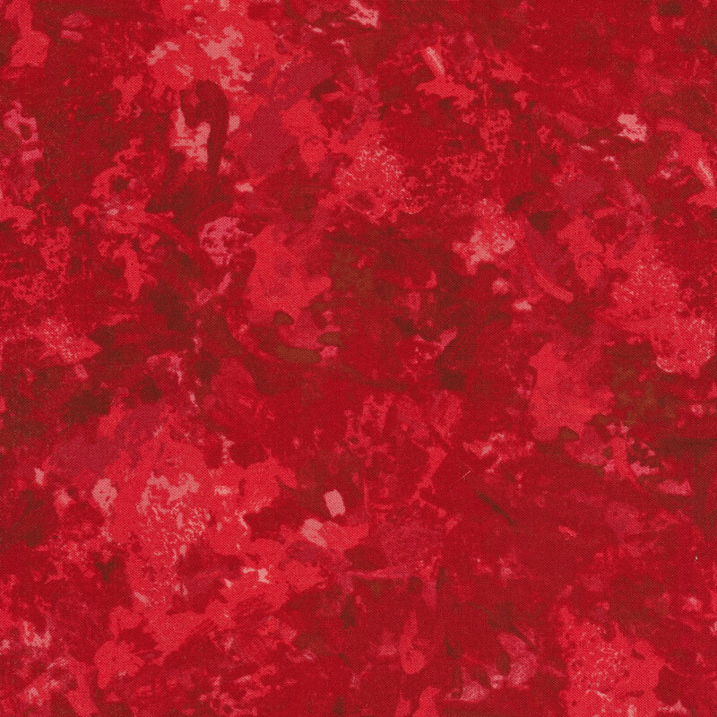 A fabric with a mottled watercolor texture in a red color