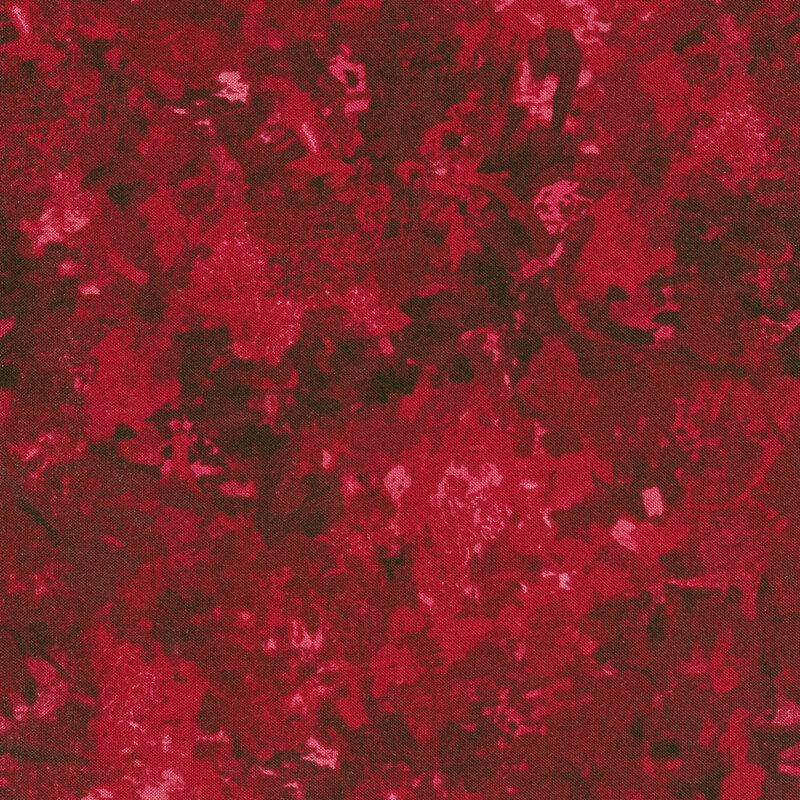 A fabric with a mottled watercolor texture in a garnet color