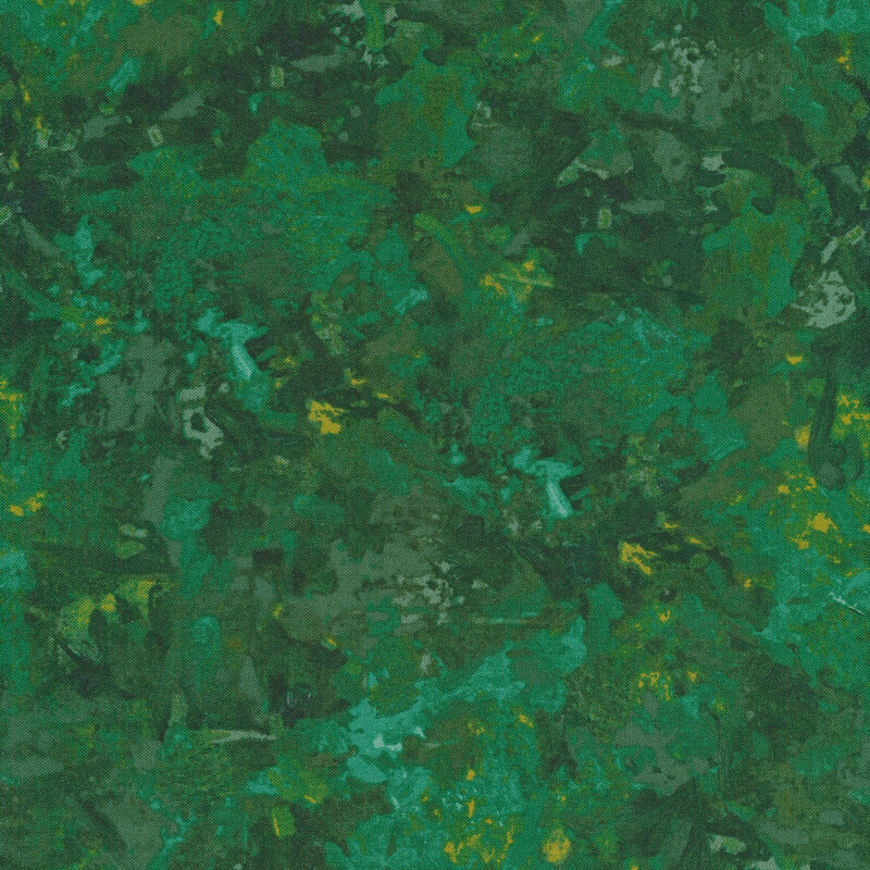 A fabric with a mottled watercolor texture in an emerald green with subtle yellow accents