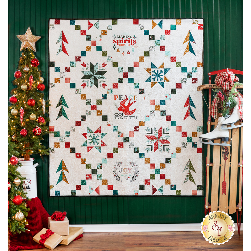 White quilt with lattice made of small squares and holiday motifs in between.