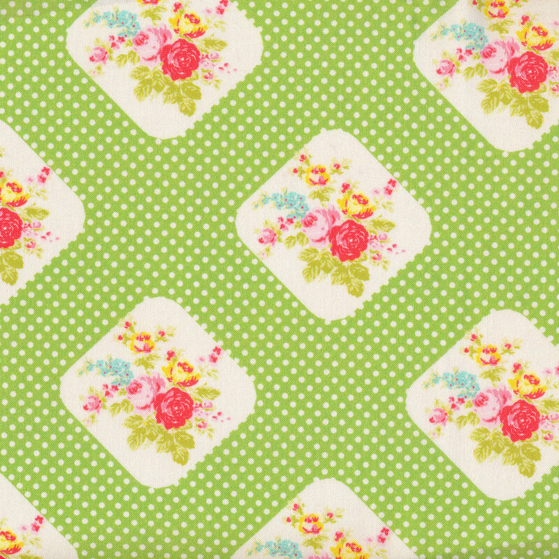 Green fabric with bouquets of roses and small white polka dots all over
