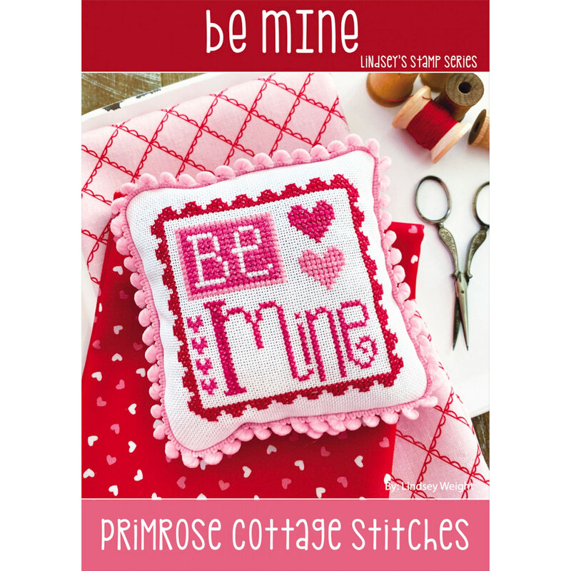 Finished Be Mine Cross Stitch Pattern embroidered on a small pillow and trimmed in pink.