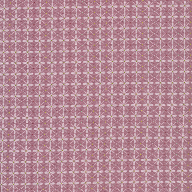 Fabric with a geometric flower pattern and small dots on a purple background