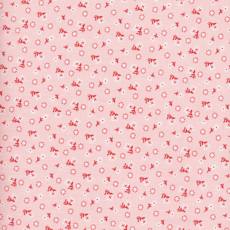 white flowers with red stems and polka dots scattered all over a light pink fabric background
