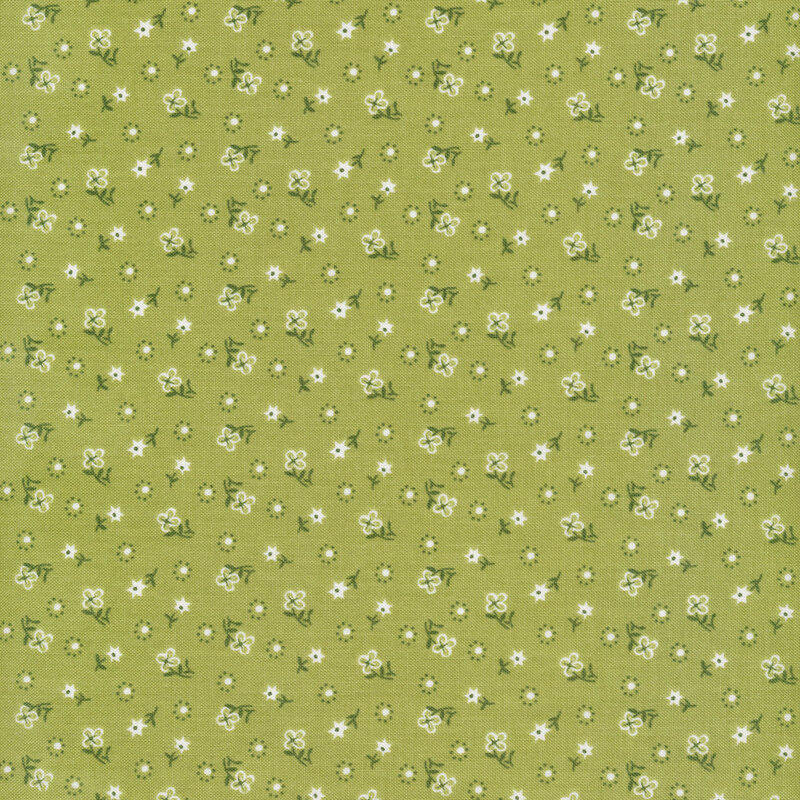 white flowers with green stems and polka dots scattered all over a green fabric background