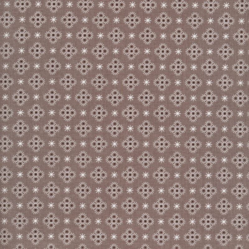 asterisks and medallions on a grayish brown fabric background