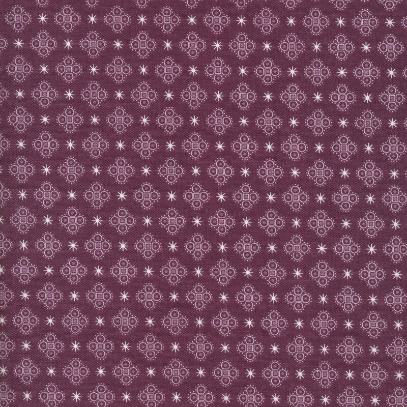 asterisks and medallions on a purple fabric background