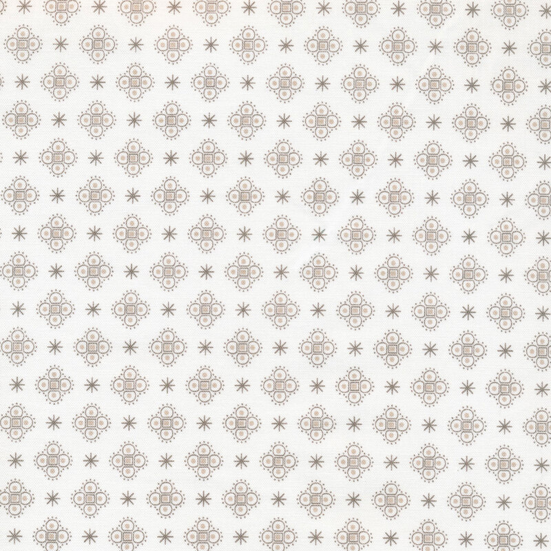 asterisks and medallions on a white fabric background