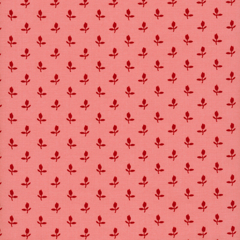 Fabric of a ditsy red rosebud flower print on a pink background.