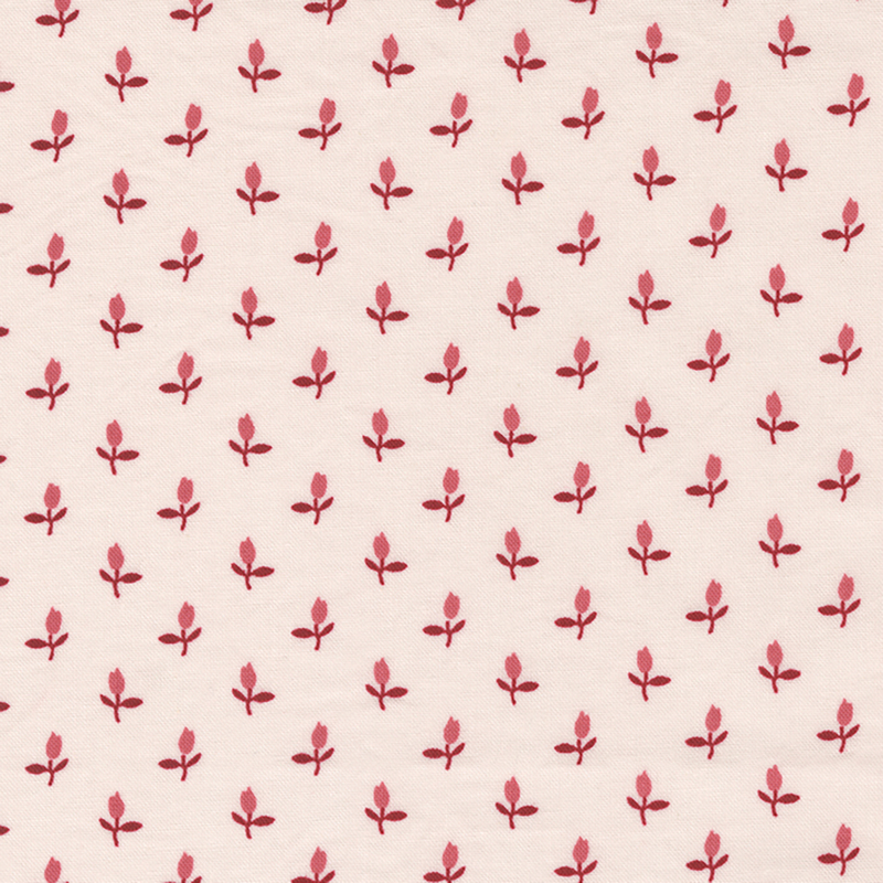 Fabric of a ditsy pink rosebud flower print on a light blush background.