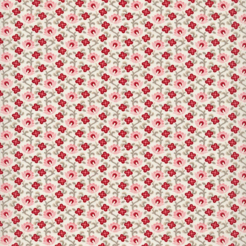 Fabric of a pink and red floral and vine print on an off-white background.