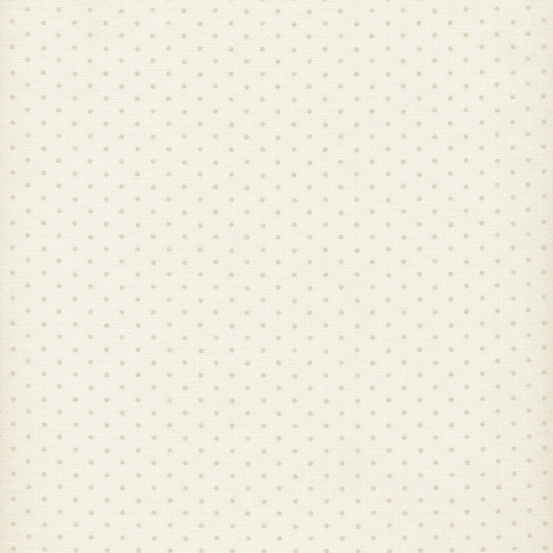 Fabric of tan polka dots on a cream background.