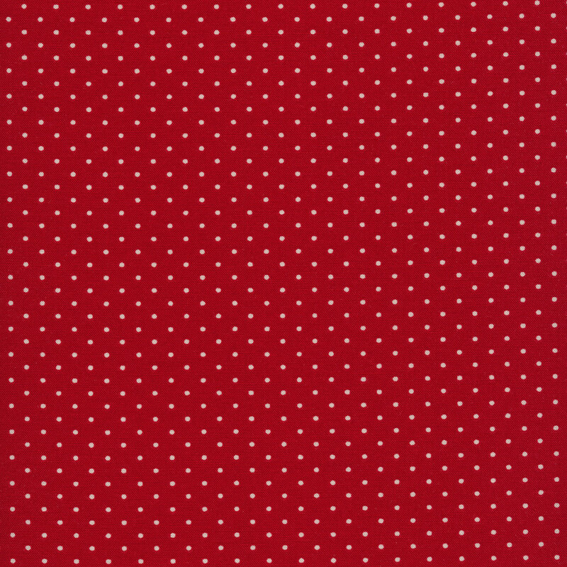 Fabric of white polka dots on a red background.