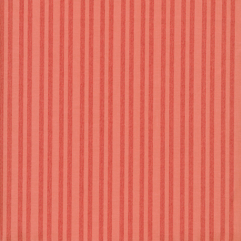 Fabric of red stripes with a ticking pattern on a pink background.