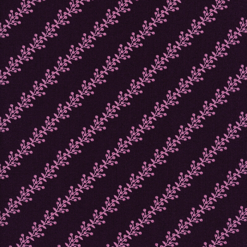 Fabric of pink berries and vines in a striped pattern on a dark purple background