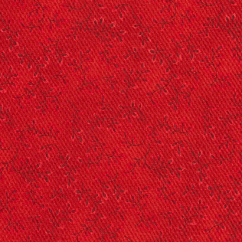 Tonal red colored fabric with leaves and vines all over