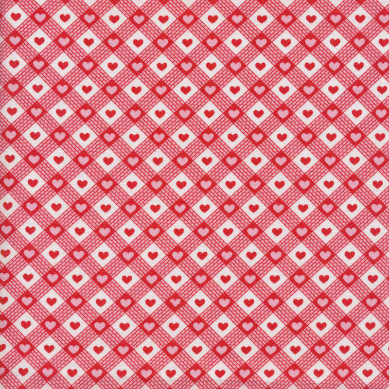 Fabric of a red bias plaid print with small hearts on a white background