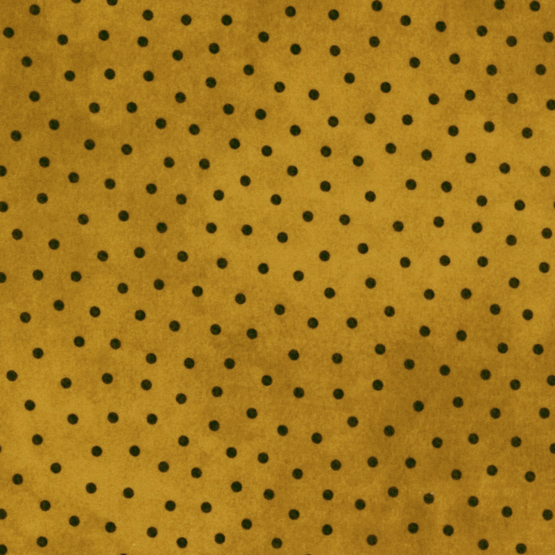 ochre yellow mottled flannel fabric with black polka dots