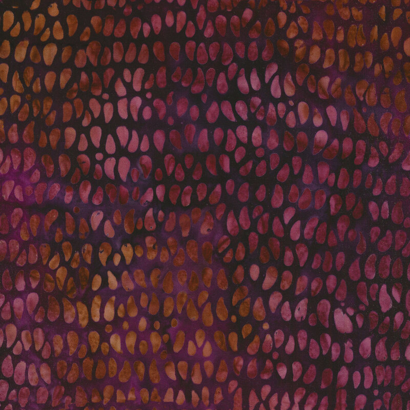 Mottled fabric of tan and mauve teardrop dots on a purple background.