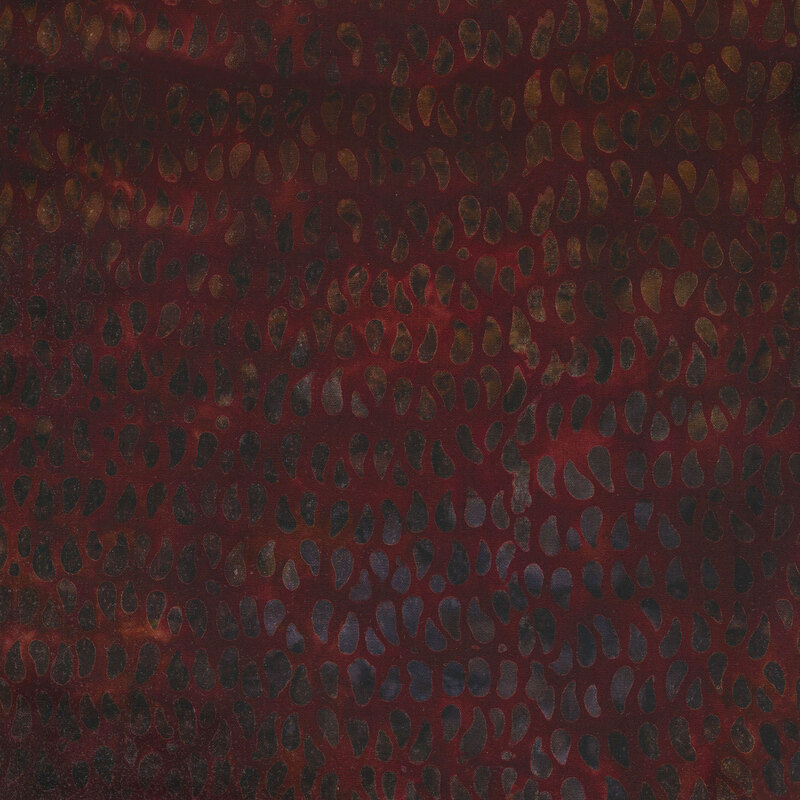 Mottled fabric of brown and dark gray teardrop dots on a deep red background.