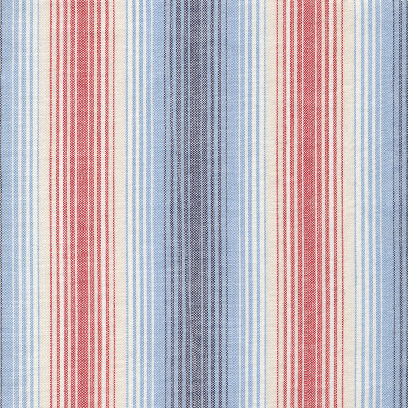 Woven fabric of stripes in varying sizes in light blue, navy, red, cream, and white.