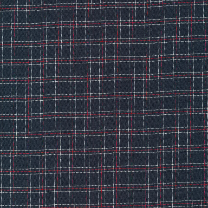 Woven fabric of a cream and red plaid pattern on a navy blue background