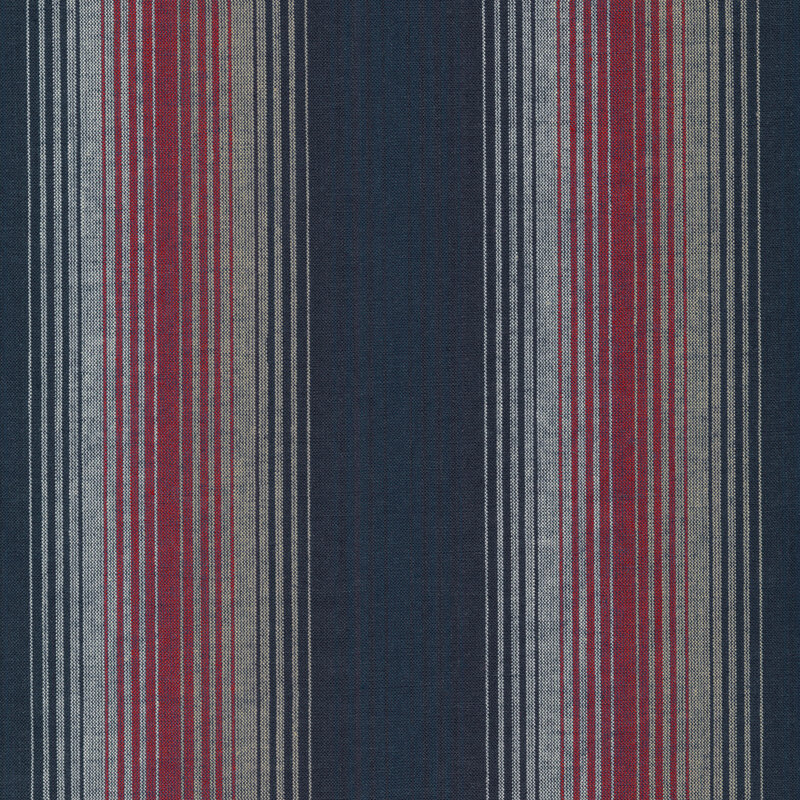 Woven fabric of stripes in varying sizes in blue, navy, red, tan, and white.