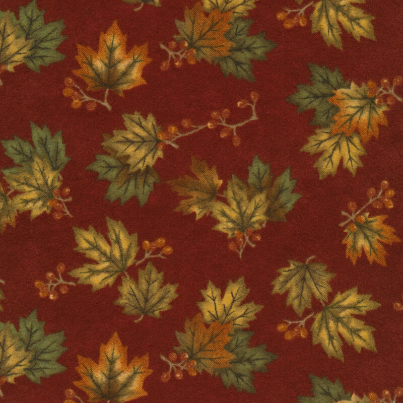 Flannel fabric of maple leaves and sprigs on a red background.