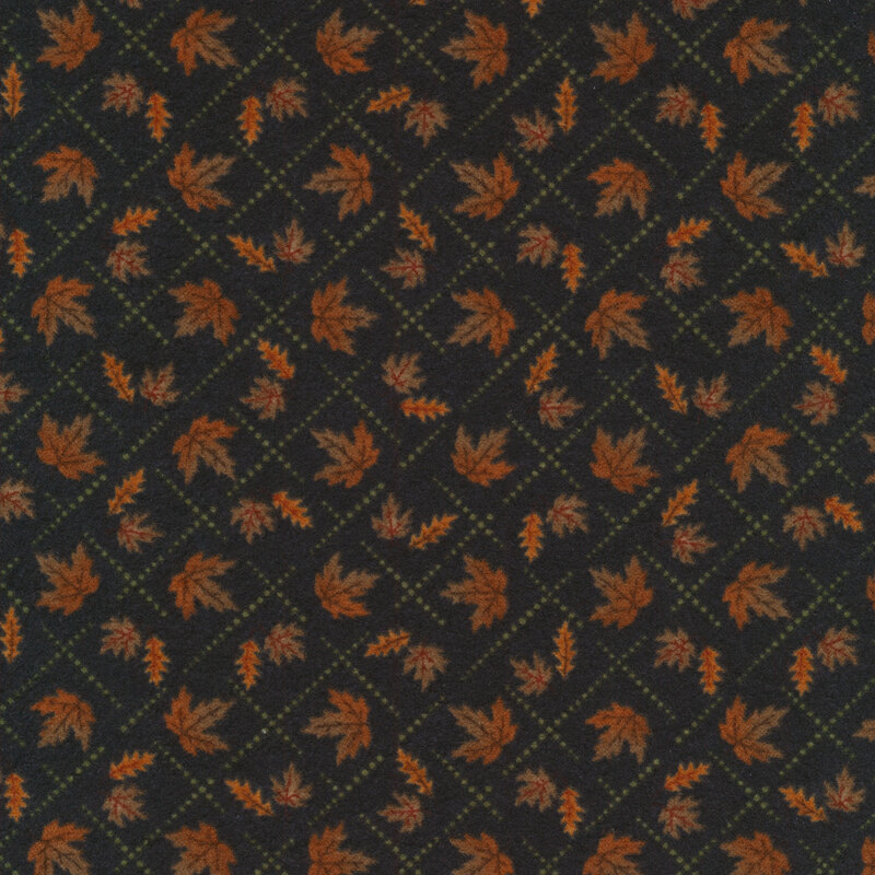 Flannel fabric of small maple leaves inside a lattice print on a black background.
