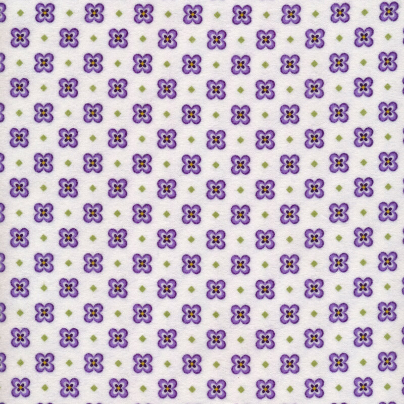 Fabric of a pansy and small diamond print and on a white background.