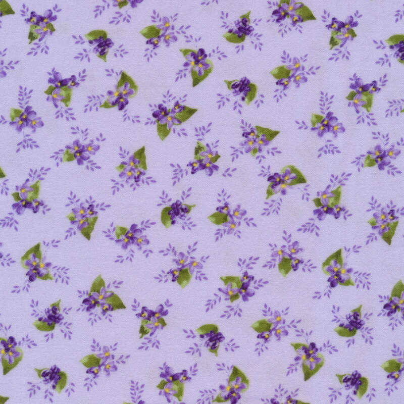 Fabric with a ditsy print of small clusters of lilacs with leaves and vines on a light purple background.