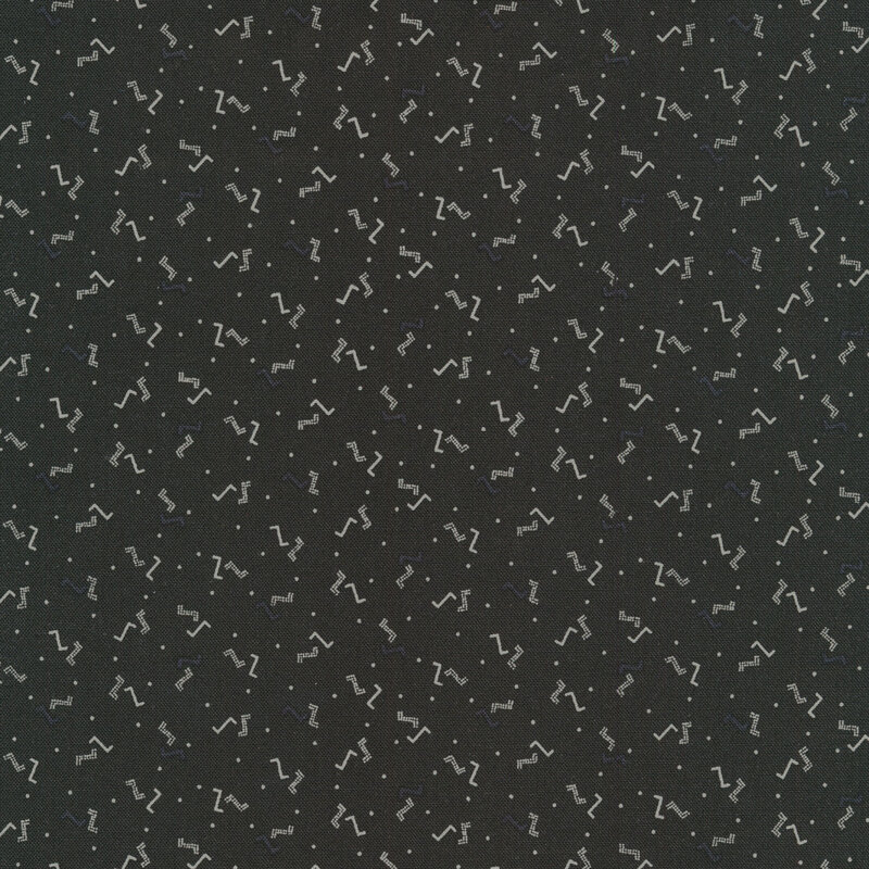 Black sewing fabric with small white dots and Z's all over