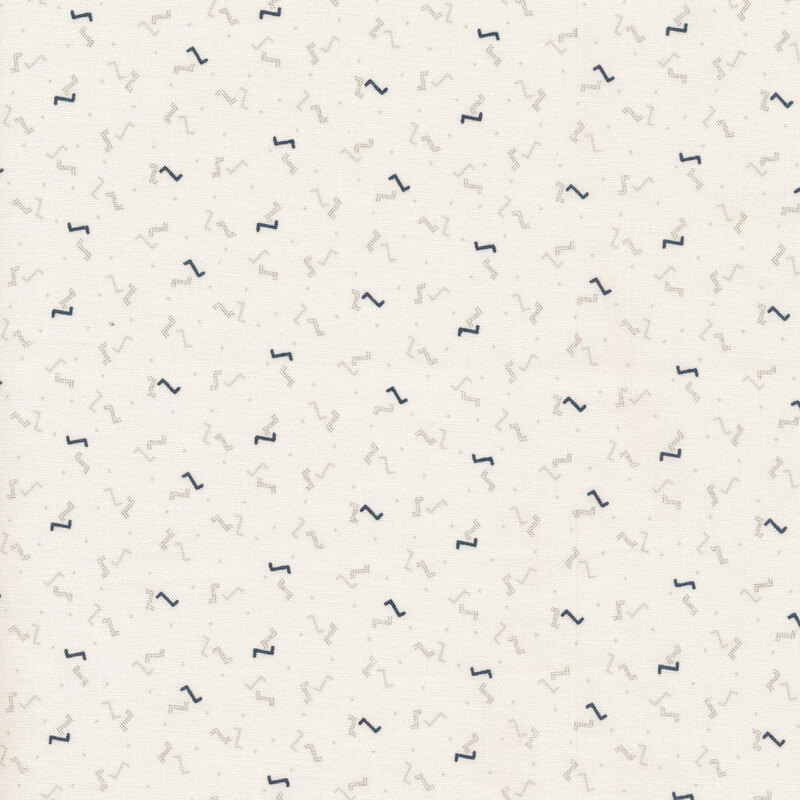 Cream sewing fabric with small white and black dots and Z's all over