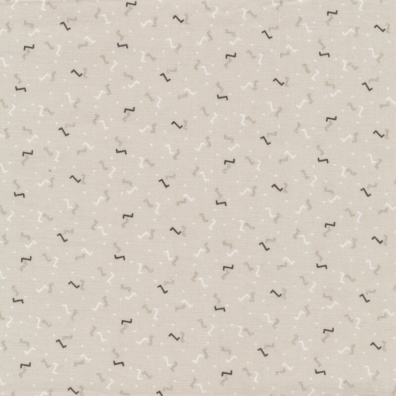 Taupe sewing fabric with small white and black dots and Z's all over