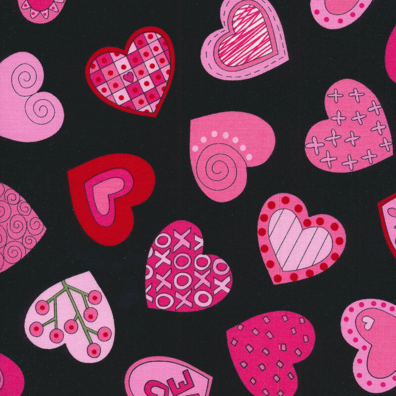 Black sewing fabric with pink and red hearts full of swirls, scrolls, wreaths, dots and more