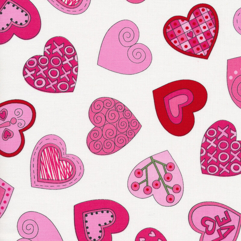 White sewing fabric with pink and red hearts full of swirls, scrolls, wreaths, dots and more