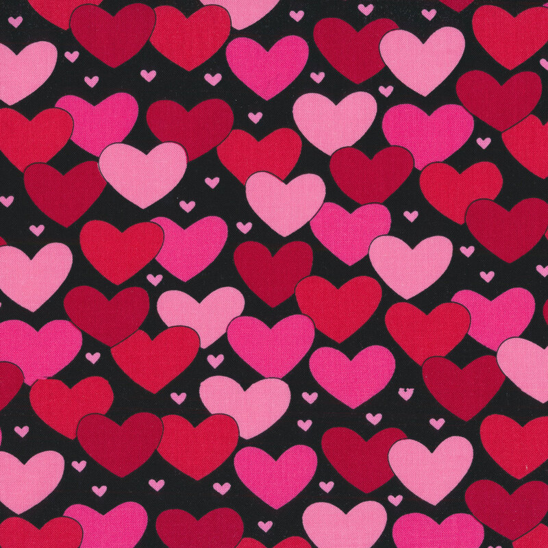 Black fabric with red, pink, and light pink hearts all over