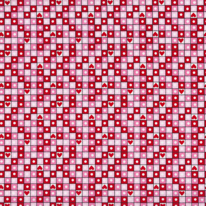 A pink Valentine's day fabric with red, pink, and light pink squares in a grid pattern with circles and hearts