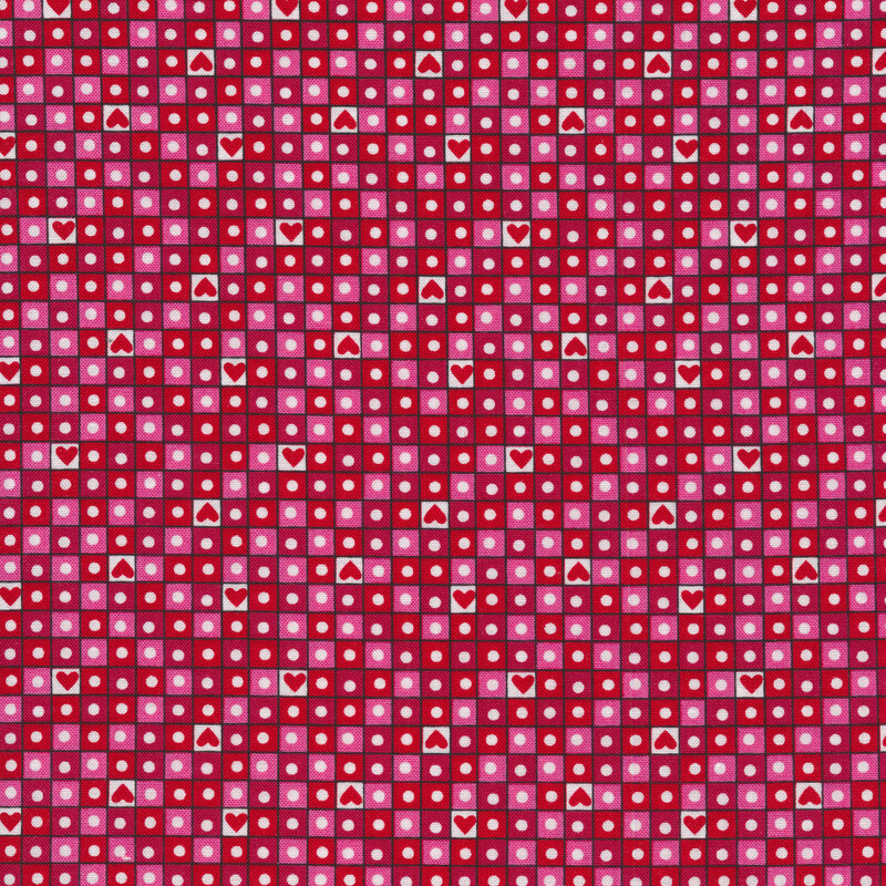A red Valentine's day fabric with red, pink, and light pink squares in a grid pattern with circles and hearts