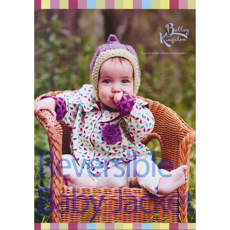 front of Reversible BAby Jacket pattern booklet showing a baby wearing a knit cap and jacket sitting in a wicker chair outside