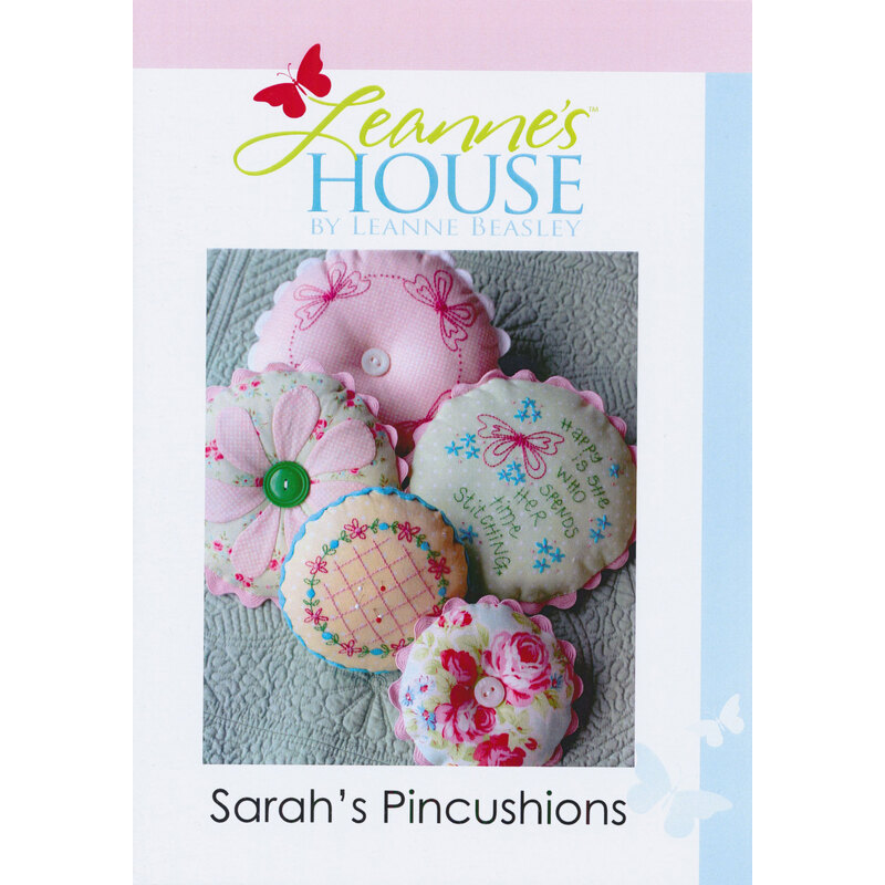 the front of the pattern booklet featuring five finished pincushions on a pale blue blanket