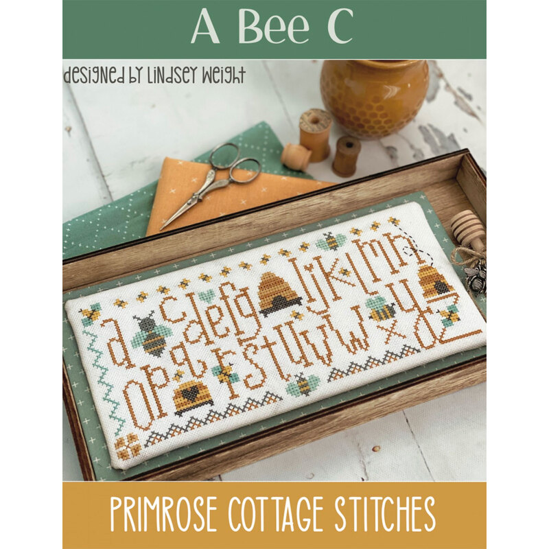 The front of the A Bee C pattern by Lindsey Weight for Primrose Cottage Stitches showing the finished project