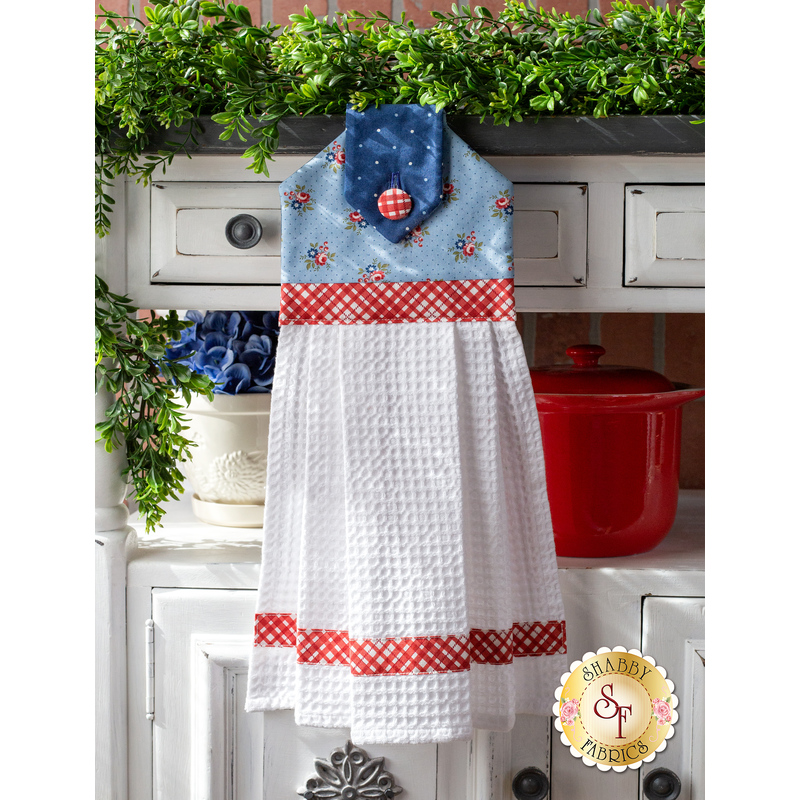 Hanging towel featuring a blue floral print and red and white plaid accents.