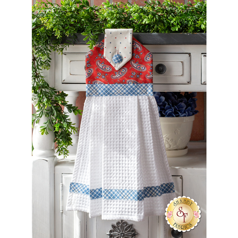 Hanging towel featuring a red paisley print and blue and white plaid accents.