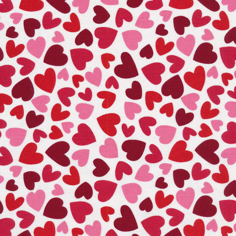 Fabric with red and pink hearts all over a white background