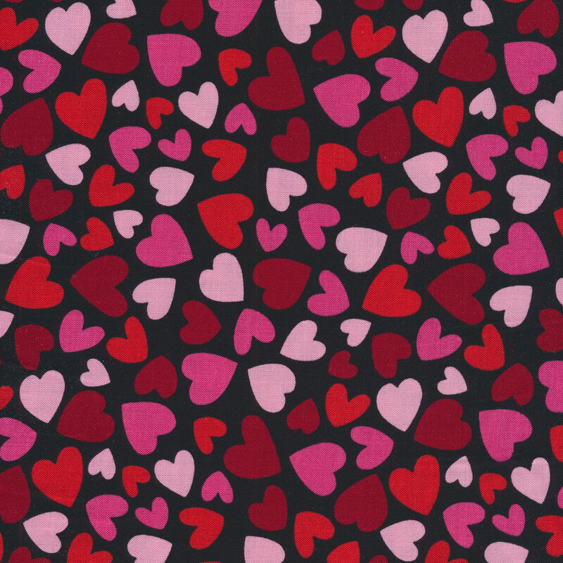 Fabric with red and pink hearts all over a black background